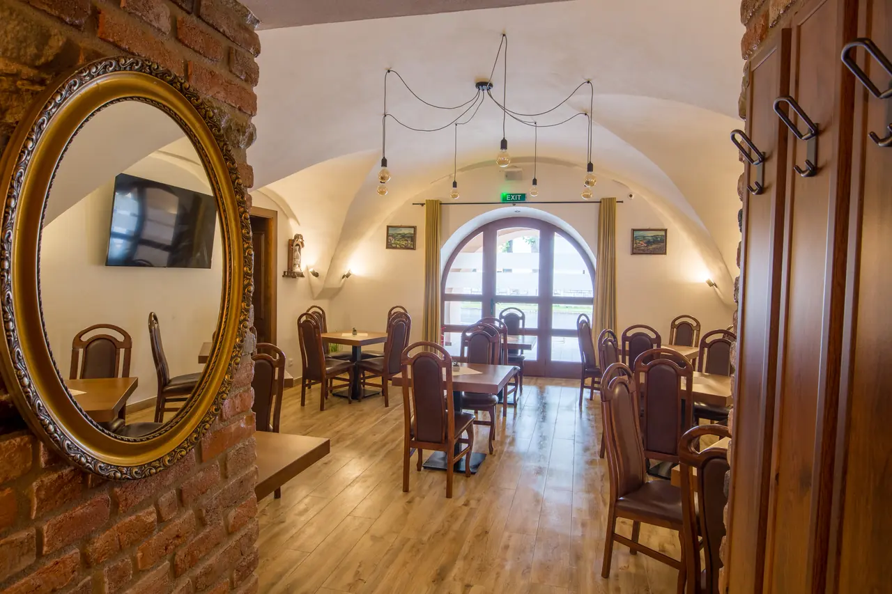 Dining room with a large mirror and arched doors