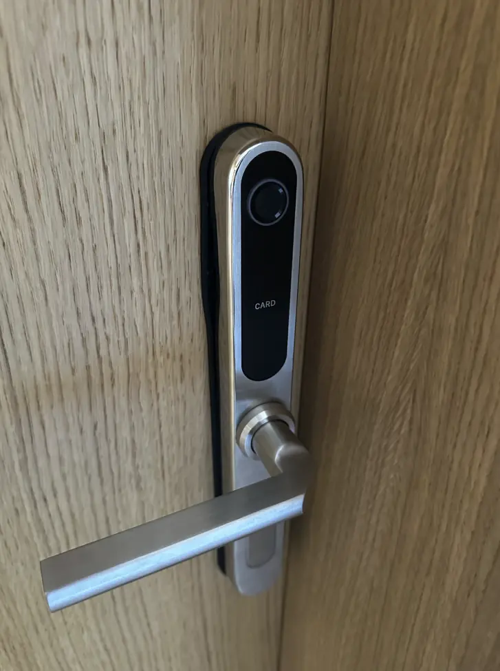 Room handle with a black touch panel and card reader